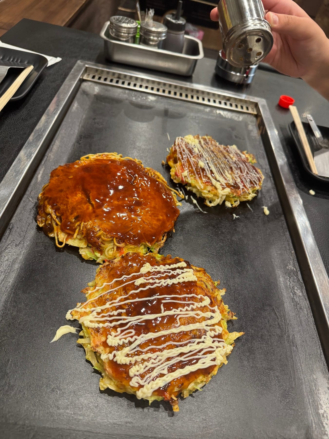 Okonomiyaki is a pancake made with vegetables, egg, sometimes noodles and usually meat or seafood. Regions tend to have