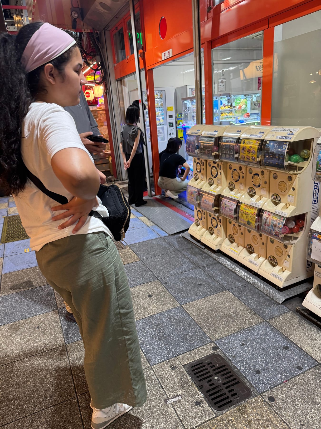Anna looking at some non-X rated gotcha machines. You put a coin in and get a mystery trinket, similar to what we have i