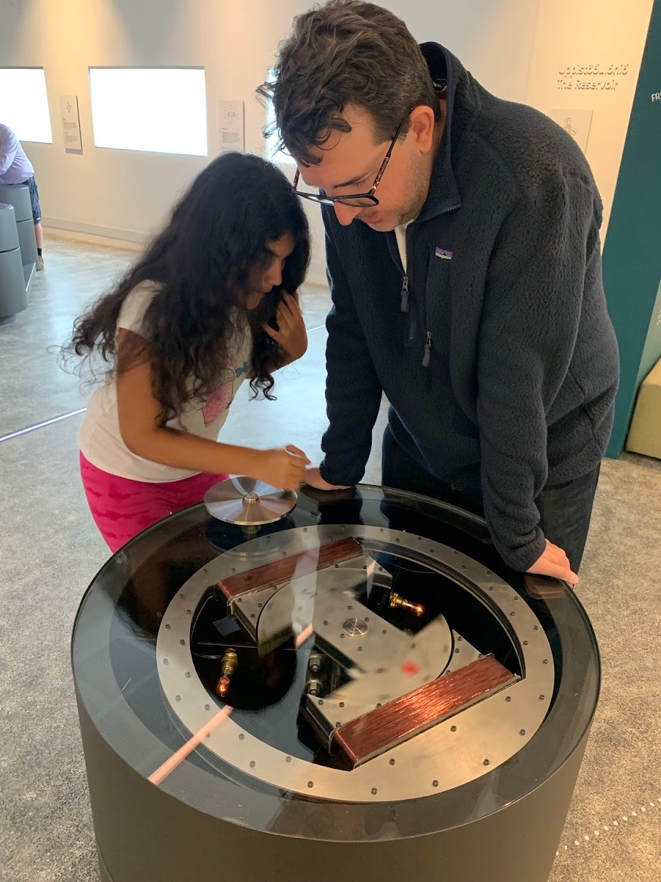 This exhibit demonstrated how electricity is created with copper wire and magnets. Anna was spinning the center of the c