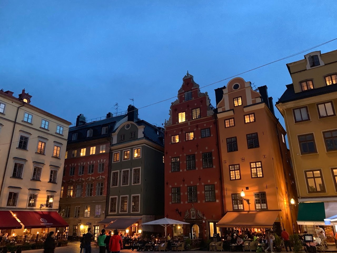 This is a row of buildings along the square in front of the Nobel Museum. You can see the cafes with lots of people enjo
