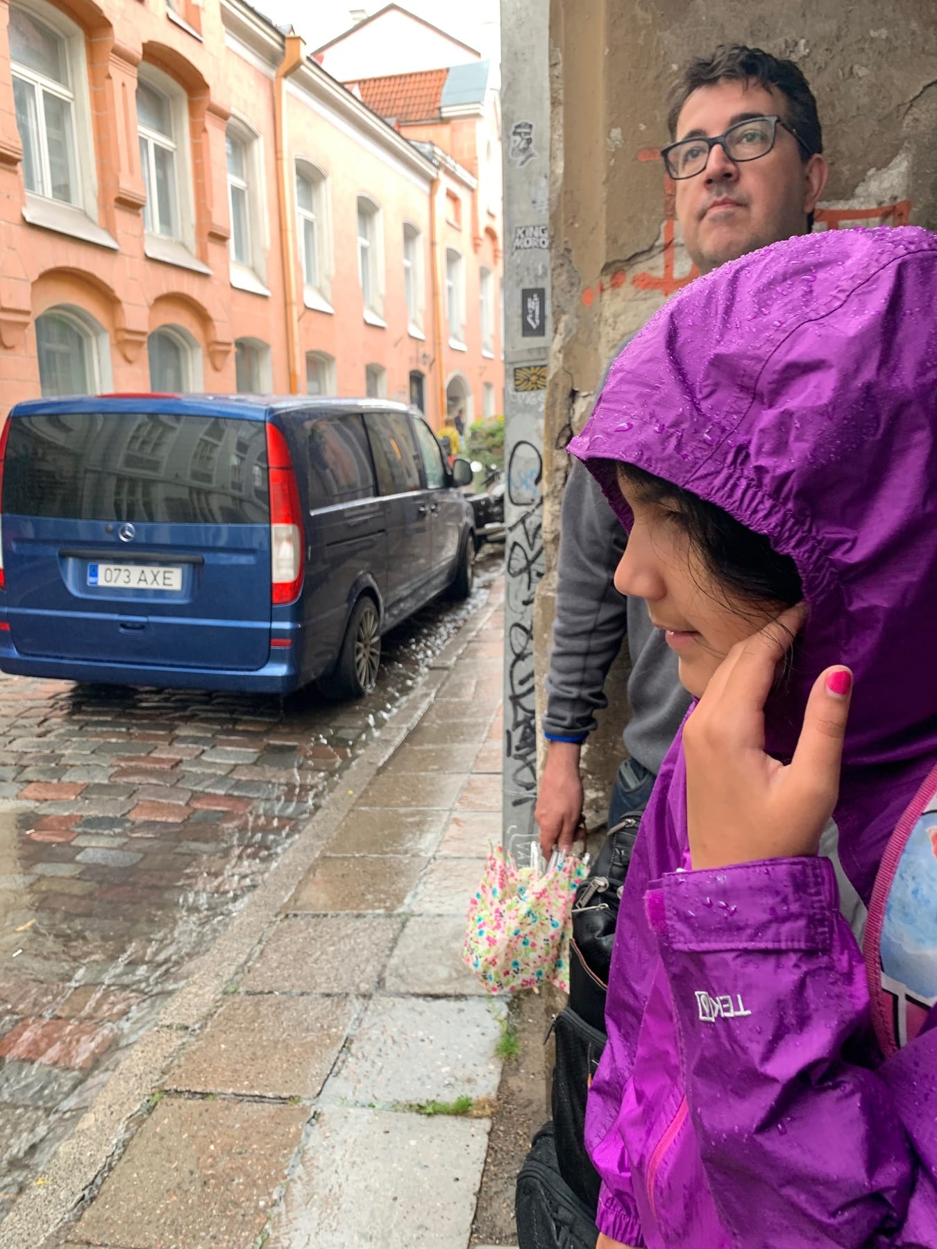Just as we left the cafe, it started to pour! We had our suitcases with us, so we lumbered over to the doorway of a gara